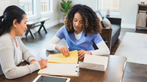 In "What Does a GLP-1 Program Actually Include?" Consultation photograph — provider reviewing intake paperwork with a client glp-1-consultation-shaped-secretz.jpg Provider reviewing a medical weight loss intake form with a client at Shaped Secretz